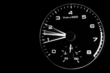Close up shot of a speedometer in a car. Car dashboard. Dashboard details with indication lamps.Car instrument panel. Dashboard with speedometer, tachometer, odometer. Car detailing. Modern interior. 