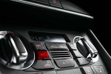 Obraz na płótnie Canvas Air conditioning button inside a car. Climate control AC unit in the new car. Modern car interior details. Car detailing. Car inside