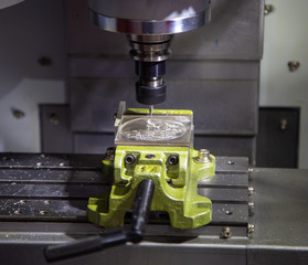 Fototapeta na wymiar High precision CNC machining center cutting plastic workpiece. Industrial manufacturing