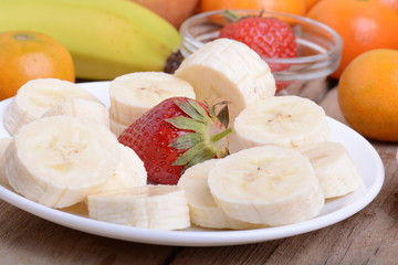 Close-up shot of variety of fruits on old wooden plate