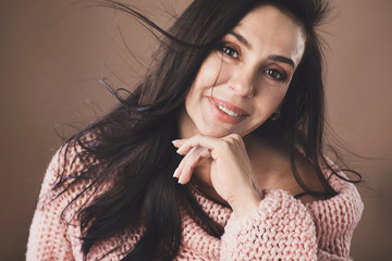 Portrait of beautiful middle aged woman wearing warm woolen sweater