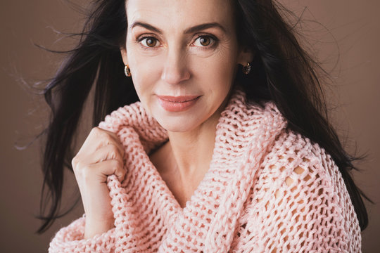 Portrait of beautiful middle aged woman wearing warm woolen sweater