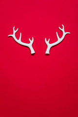 White winter festive christmas reindeer antlers on a red background