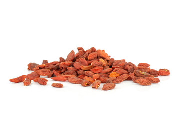 Lot of whole dried red goji berries heap isolated on white background