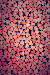 Tiny red hearts on dark background.