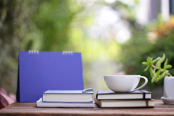 Ceramic white coffee cup with blue carlendar and notebooks