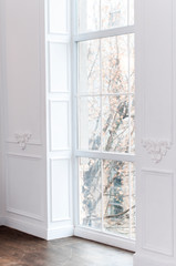 large window in the floor in the room with white walls