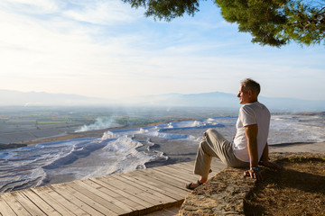 Traveler relaxes under lush pine trees