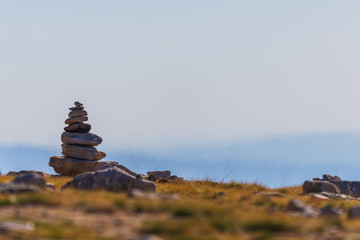 Fototapeta na wymiar Zen balanced stones stack in high mountains. Scenic mountain view.