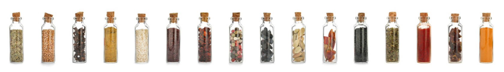 Glass bottles with different spices and herbs on white background. Large collection