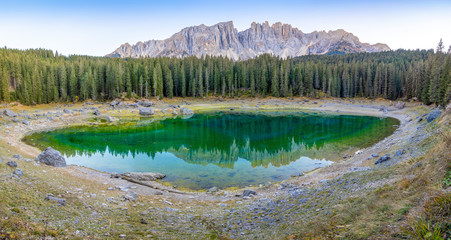 Karersee or Lago di Carezza, is a lake with mountain range of the Latemar group on background in the Dolomites in Tyrol, Italy