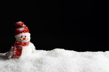 Decorative snowman on black background, space for text. Winter weather