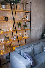 Interior of modern living room with comfortable sofa decorated with Christmas tree and gifts