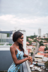 Fototapeta premium Pensive trendy woman on balcony above city