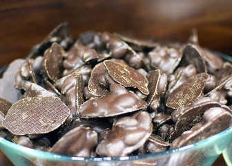 chocolate coated cookies in a bowl blurred