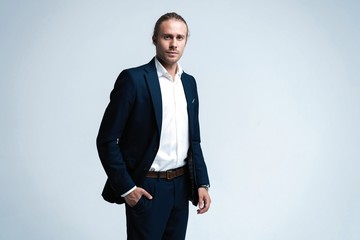 Portrait of handsome man in dark blue suit.