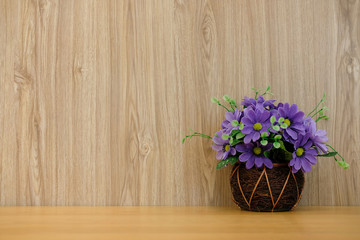 purple artificial flower on wooden table at office