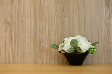 white artificial flower on wooden table at office