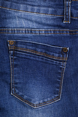 Close-up. The view of the back pocket of denim trousers.