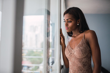 Young black woman in lace bodysuit