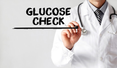 Doctor writing word Glucose Check with marker, Medical concept