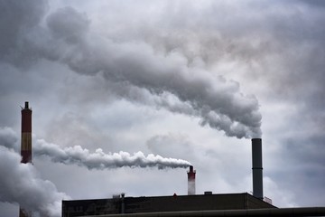 Smoky chimney factory polluting the environment and the air.