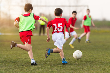 Young children player on the football match
