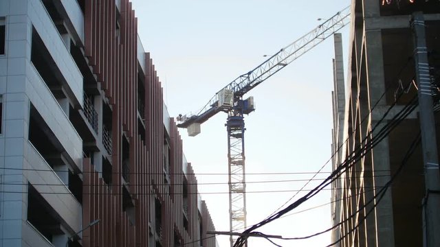 Industry construction and development. Concrete walls. Working construction crane