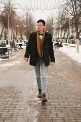 Fototapeta premium Young man with a urban look in city. hipster man in the city winter