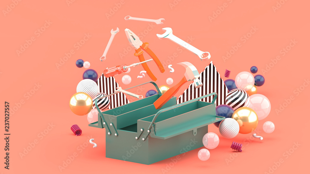 Wall mural Toolbox amidst colorful balls on a pink background.-3d rendering.