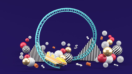 A blue roller coaster among colorful balls on a purple background.-3d rendering. - obrazy, fototapety, plakaty