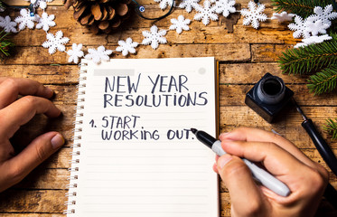 Person writing new year resolutions