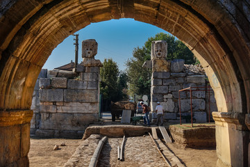 Iznik(Nicaea), Bursa/Turkey - September 15, 2017: Istanbul gate from Iznik(Nicaea) Ancient City. Archaeological excavation working with worker. Theater masks over the Iznik wall.
