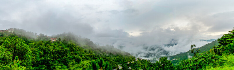 clouds floating over the mountain range as seen while driving to Binsar, near Almora, Uttarakhand,. rainy season, monsoon India