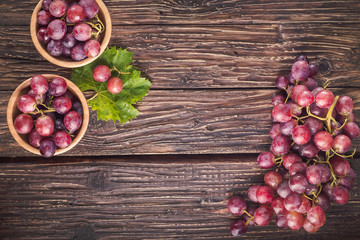 Red grapes on rustic wood background with copy space, top view, close-up. - 237028532