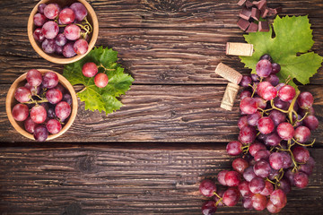 Grapes bunch with leaves on rustic wooden background. Top view, copy space. Free space for text. - 237028597