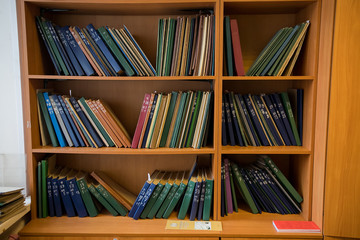 Bookshelf in library with many books.
