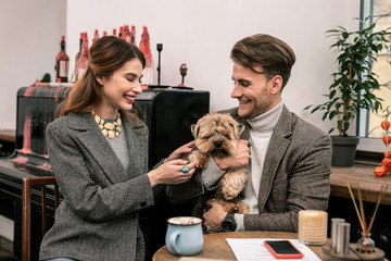 Woman touching a paw of her boyfriends dog