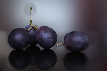 Bunch of ripe black grapes lying on the table
