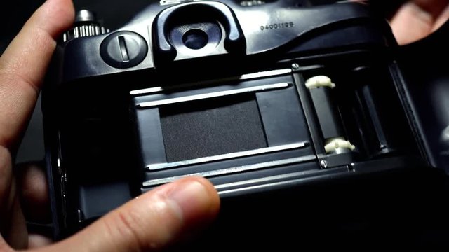 Man trying to run your old camera. Film camera rewind. 4K
