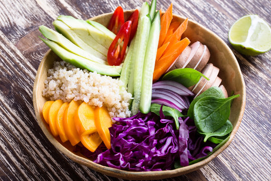 Quinoa veggie bowl with colorful fresh vegetables and fruits