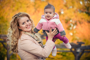 mother and daughter in autumn park