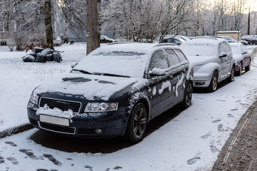 Parked cars covered with snow after snow storm.