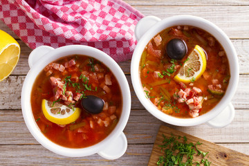 Traditional Russian dish  solyanka - thick, spicy and sour saltwort soup.  View from above, top studio shot