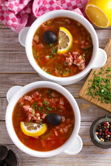 Traditional Russian dish  solyanka - thick, spicy and sour saltwort soup.  View from above, top studio shot