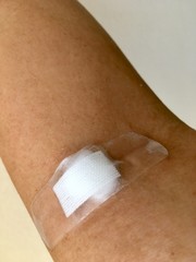 Plaster and cotton patch on the arm after the blood test.