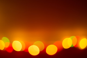 colorful bokeh lights on a red-brown background