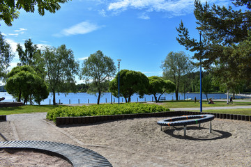 Children's playground near the lake during a sunny, summer day.