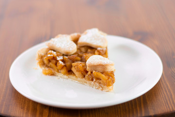 Apple pie served in glass service plate with isolated black background