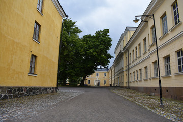 Fototapeta na wymiar Yellow, old buildings and streets in Suomenlinna Sea Fortress, a UNESCO World Heritage Site, in Finland.